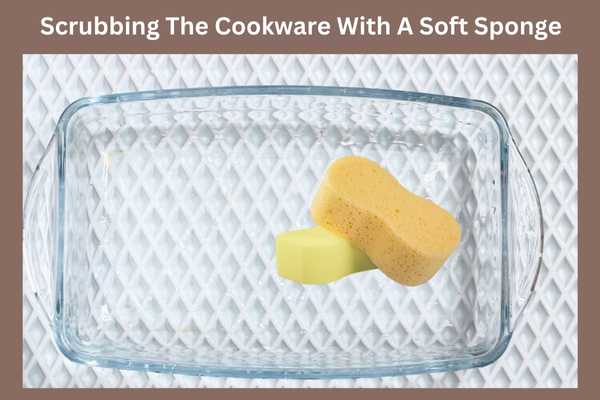Scrubbing The Cookware With A Soft Sponge