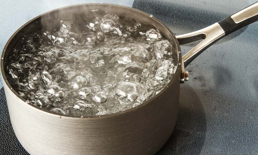 boiling a cleansing mixture to clean all clad cookwares