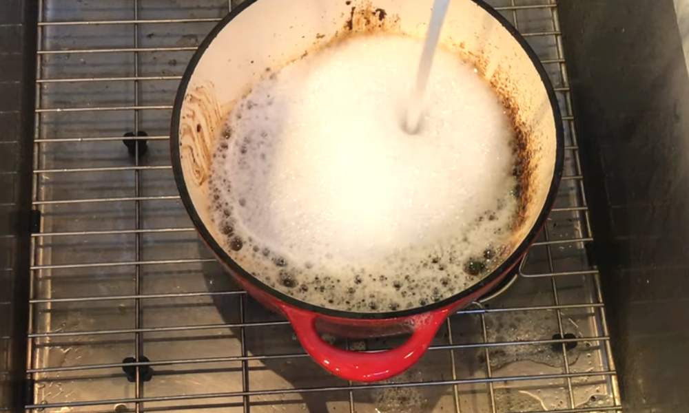 Clean Discolored Enamel Cookware with soap and water